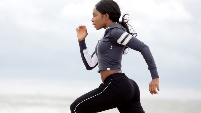 Black woman running with high intensity