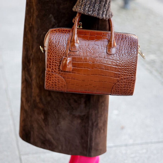 Influencer Annette Weber is seen toting a brown crocodile-skin bag during a street-style shoot at Berlin Fashion Week AW23 on January 19, 2023.